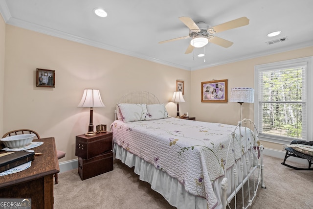 carpeted bedroom featuring ceiling fan and crown molding