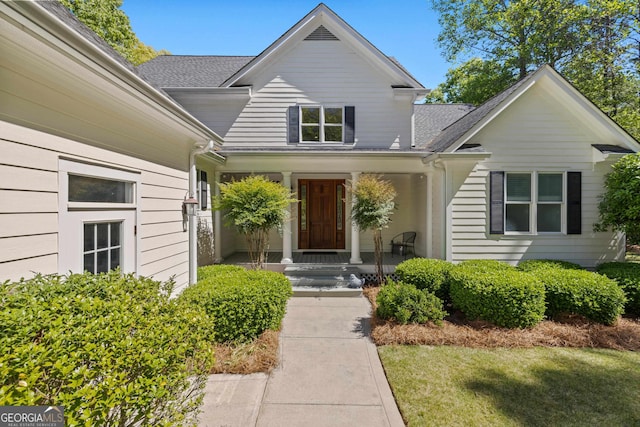 doorway to property with a lawn