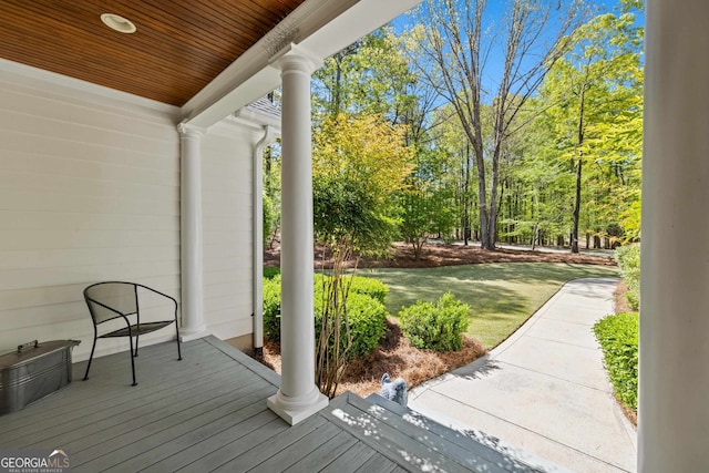 wooden deck with a lawn