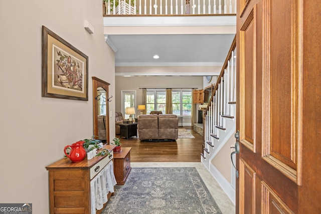 foyer featuring dark hardwood / wood-style floors and crown molding