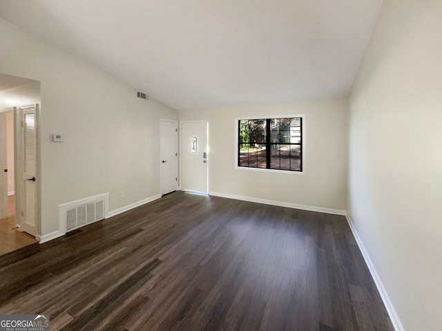 spare room with dark wood-type flooring