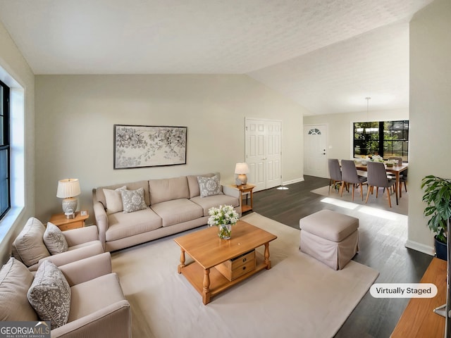 living room featuring dark hardwood / wood-style floors and lofted ceiling