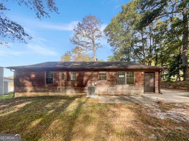 single story home featuring a front lawn, central AC, and a patio area