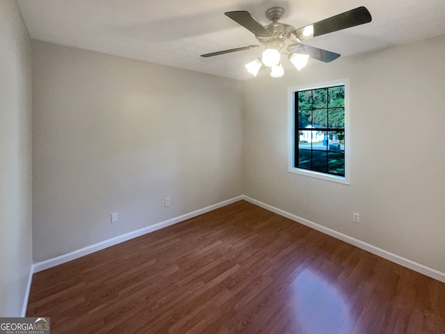 spare room featuring dark hardwood / wood-style flooring and ceiling fan