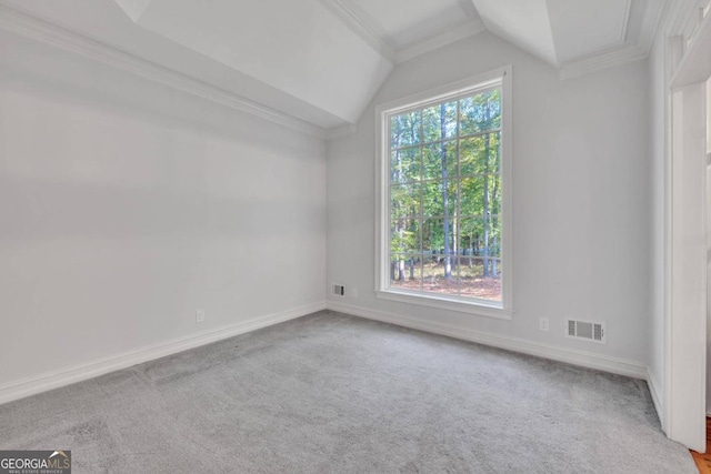 spare room with lofted ceiling, light colored carpet, and crown molding