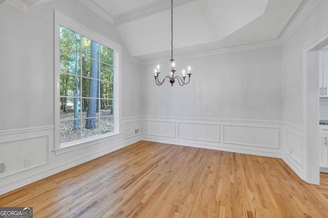 unfurnished dining area with light hardwood / wood-style floors, a notable chandelier, a healthy amount of sunlight, and crown molding