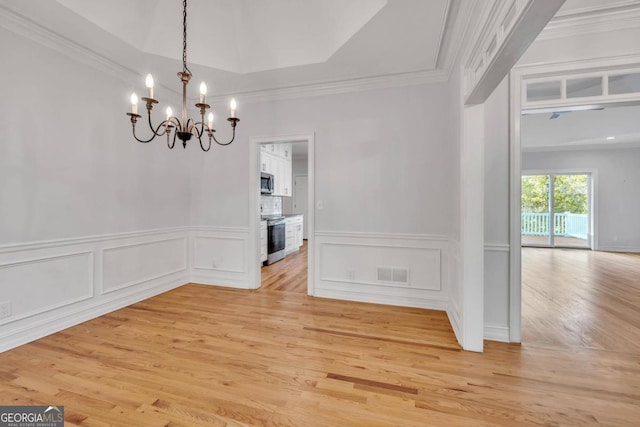 unfurnished dining area with light hardwood / wood-style flooring and crown molding