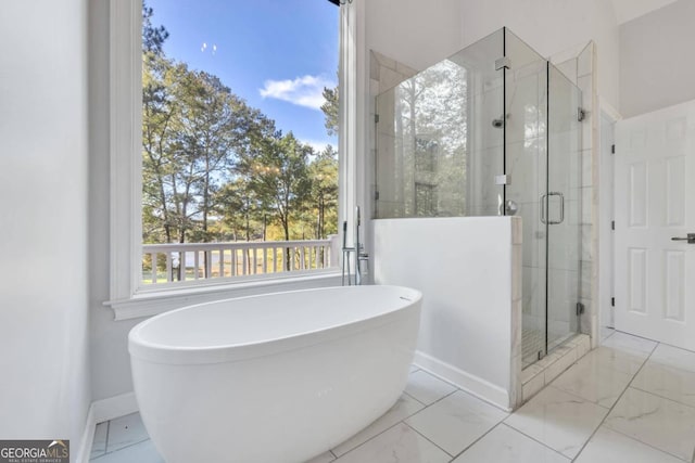 bathroom featuring shower with separate bathtub