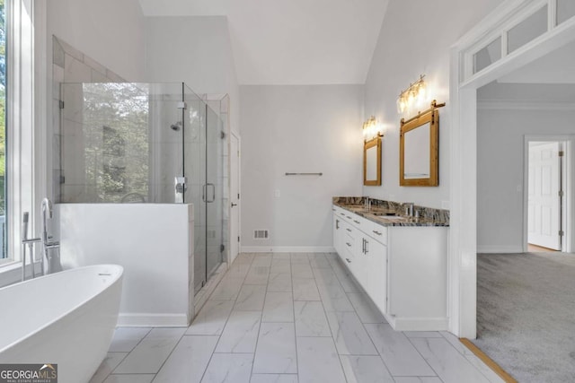 bathroom with vanity, separate shower and tub, and vaulted ceiling