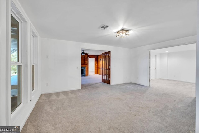 empty room with light carpet and ceiling fan