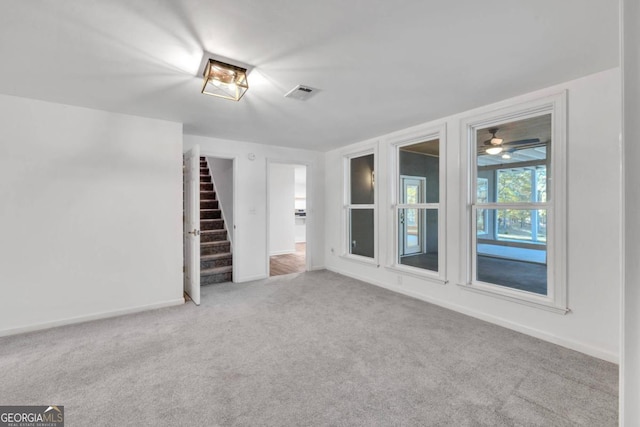 unfurnished living room with light colored carpet