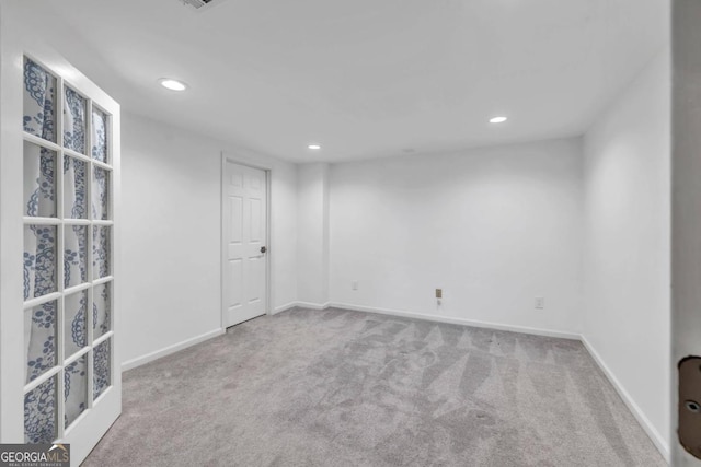 unfurnished room with light colored carpet