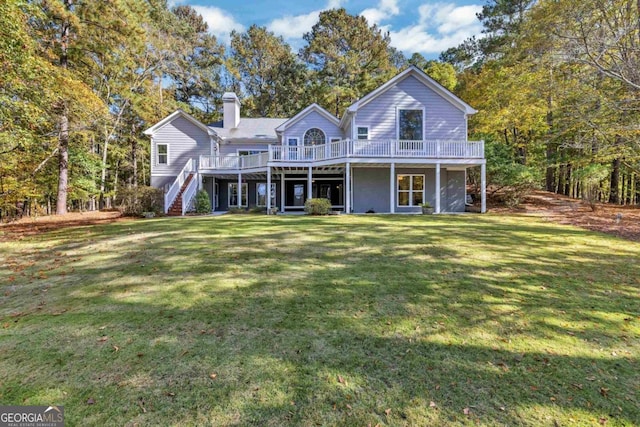 view of front of house with a wooden deck and a front lawn