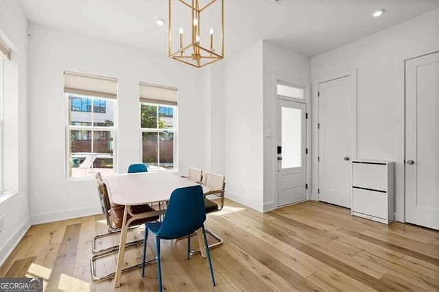 dining area featuring an inviting chandelier and light hardwood / wood-style flooring