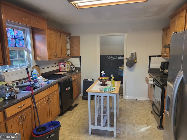 kitchen featuring decorative backsplash, black appliances, and extractor fan