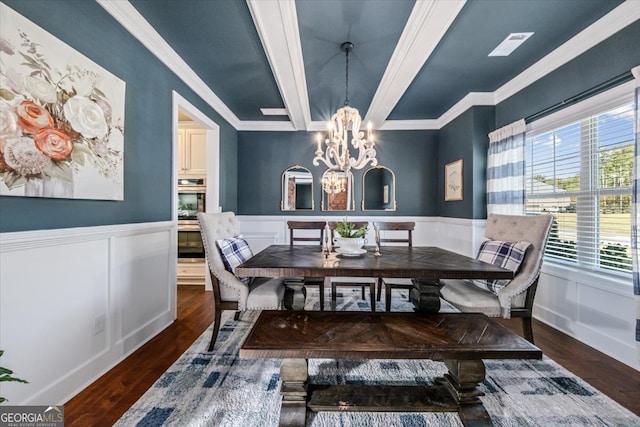 dining area featuring dark wood-type flooring, beamed ceiling, an inviting chandelier, and crown molding