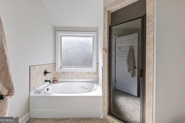 bathroom featuring tile patterned floors and shower with separate bathtub