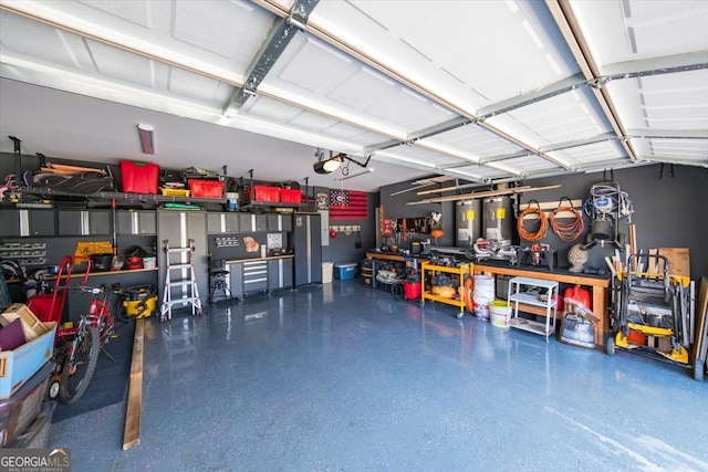 garage featuring a garage door opener and a workshop area