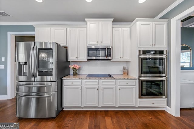 kitchen featuring stainless steel appliances, dark hardwood / wood-style flooring, light stone counters, ornamental molding, and white cabinetry