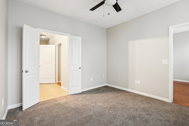 unfurnished bedroom featuring carpet flooring and ceiling fan