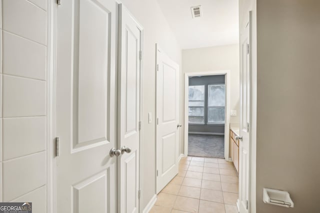 hall with light tile patterned floors