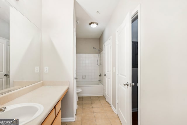 full bathroom featuring tile patterned floors, vanity, toilet, and tiled shower / bath