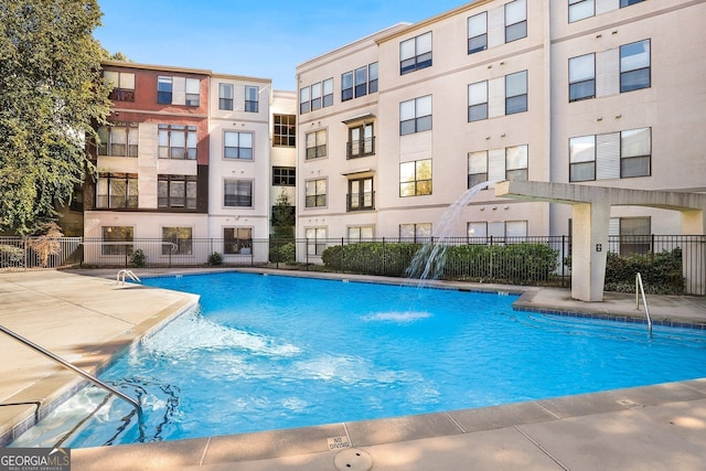 view of pool with pool water feature