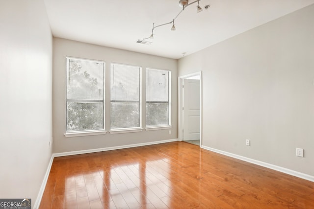 spare room with wood-type flooring