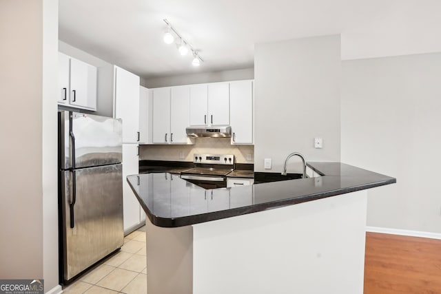 kitchen featuring white cabinets, kitchen peninsula, light hardwood / wood-style floors, and stainless steel appliances