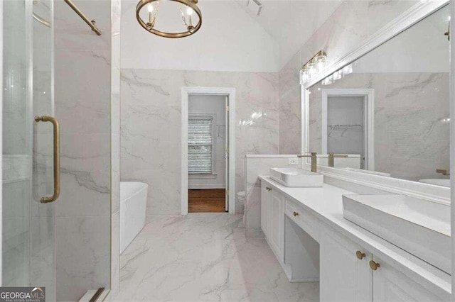 bathroom featuring a shower with shower door, vanity, and vaulted ceiling