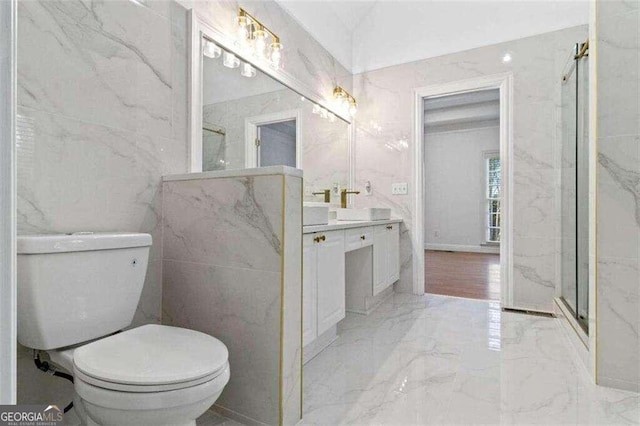 bathroom featuring walk in shower, tile walls, vanity, and toilet