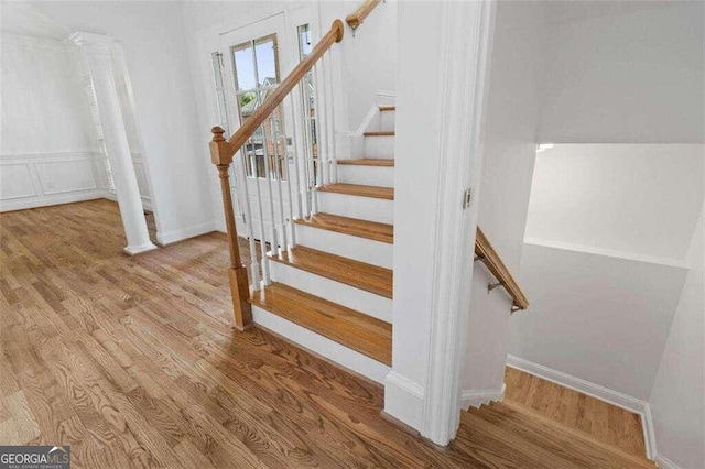 staircase with hardwood / wood-style floors