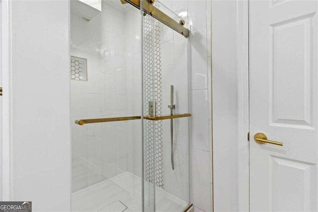 bathroom featuring a shower with door