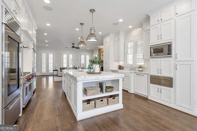 885 Crabapple Hl, Milton, GA 30004 - kitchen featuring a kitchen island, pendant lighting, white cabinetry, ornamental molding, and built in appliances
