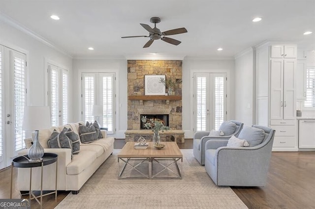 885 Crabapple Hl, Milton, GA 30004 - living room with french doors, crown molding, a stone fireplace, and light wood-type flooring