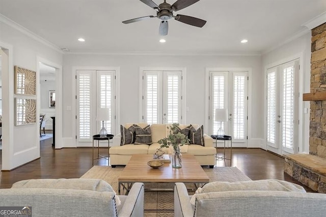 885 Crabapple Hl, Milton, GA 30004 - living room featuring a stone fireplace, dark hardwood / wood-style flooring, ornamental molding, ceiling fan, and french doors