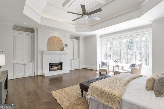 885 Crabapple Hl, Milton, GA 30004 - bedroom featuring crown molding, dark hardwood / wood-style floors, a raised ceiling, ceiling fan, and a fireplace
