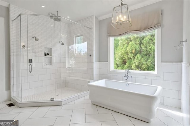 885 Crabapple Hl, Milton, GA 30004 - bathroom featuring separate shower and tub, tile walls, and tile patterned floors