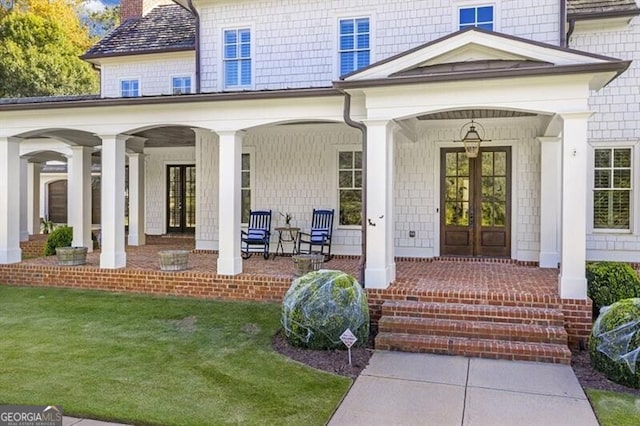 885 Crabapple Hl, Milton, GA 30004 - doorway to property featuring french doors, covered porch, and a lawn