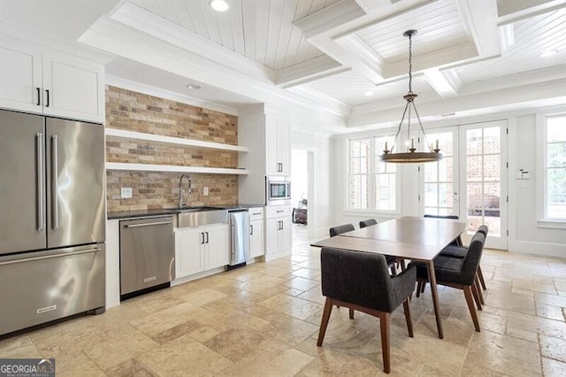 885 Crabapple Hl, Milton, GA 30004 - kitchen with decorative light fixtures, ornamental molding, appliances with stainless steel finishes, a healthy amount of sunlight, and white cabinets