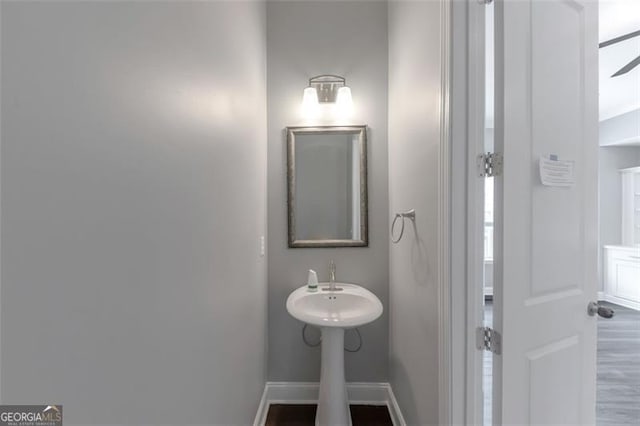 bathroom with hardwood / wood-style flooring and ceiling fan