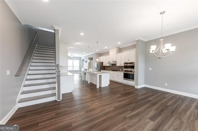 interior space with sink, a notable chandelier, dark hardwood / wood-style flooring, and ornamental molding