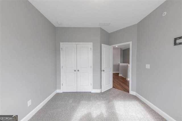 unfurnished bedroom featuring a closet and carpet