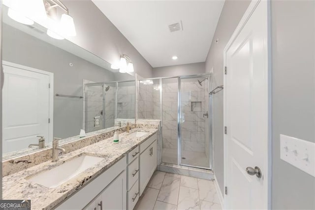 bathroom featuring an enclosed shower and vanity