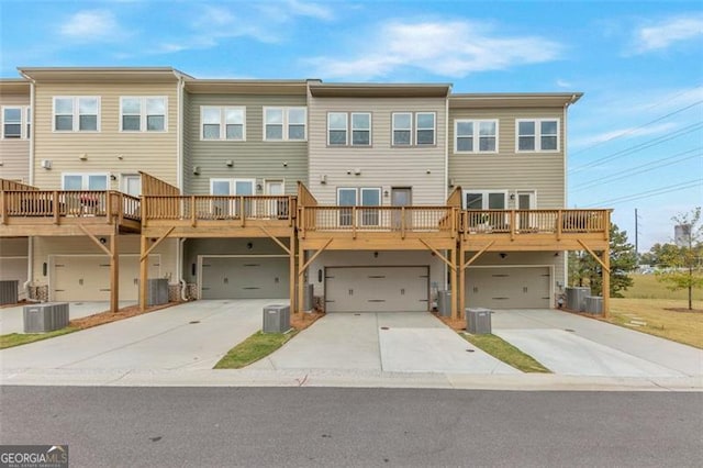 townhome / multi-family property with a garage and cooling unit