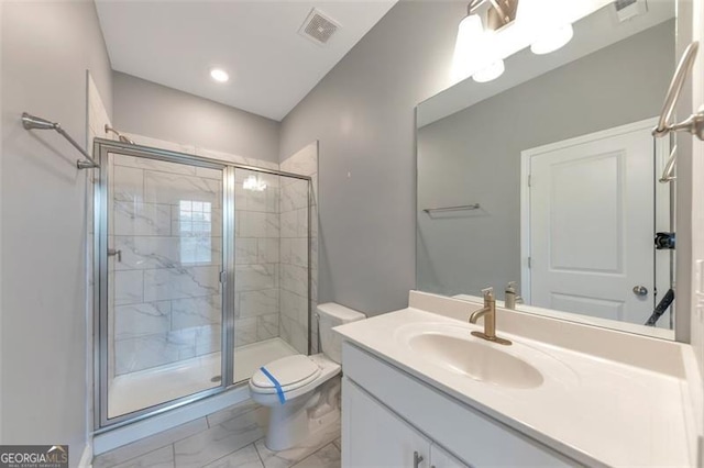 bathroom with a shower with door, vanity, and toilet