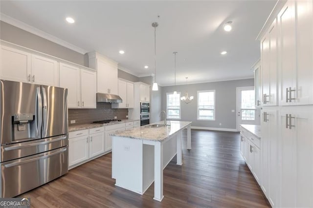 kitchen featuring an island with sink, hanging light fixtures, white cabinets, and appliances with stainless steel finishes