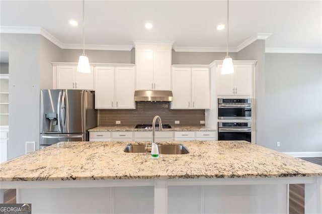 kitchen featuring pendant lighting, a center island with sink, appliances with stainless steel finishes, and sink