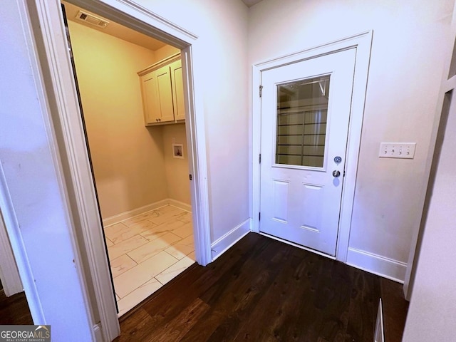 entryway with dark hardwood / wood-style flooring