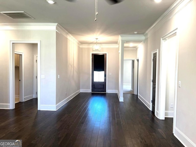 foyer featuring ornamental molding, a chandelier, and dark hardwood / wood-style floors